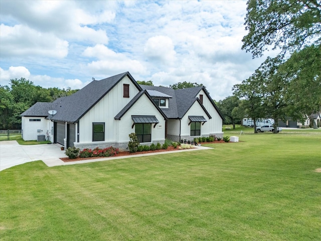 modern farmhouse featuring a garage and a front yard