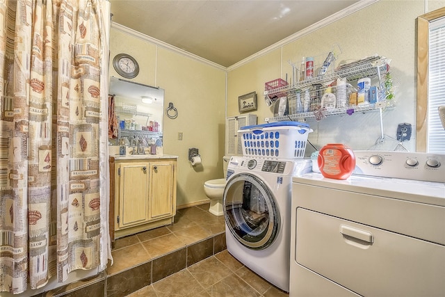 laundry room featuring separate washer and dryer, tile patterned floors, crown molding, and sink