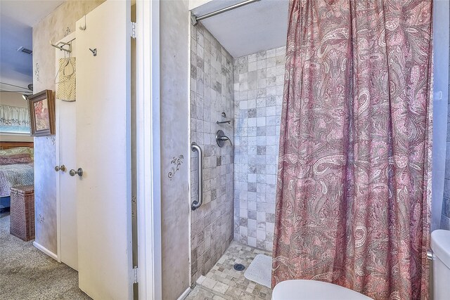 bathroom with curtained shower and toilet