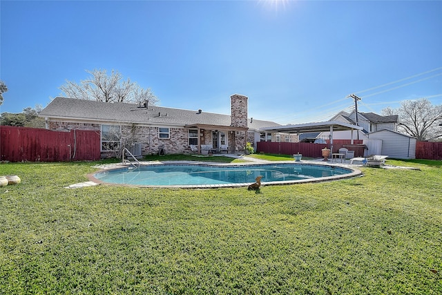 view of pool with a lawn, a diving board, a storage shed, and central air condition unit