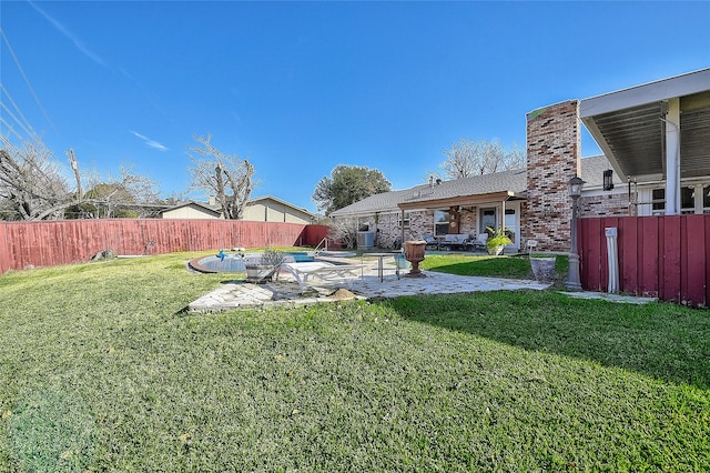 view of yard featuring a fenced in pool and a patio area