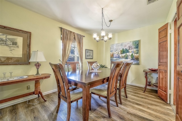 dining space featuring a chandelier and hardwood / wood-style flooring