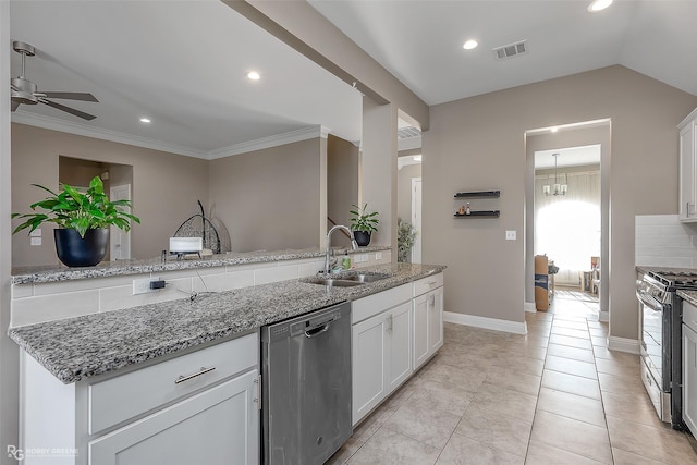 kitchen with sink, ceiling fan, appliances with stainless steel finishes, light stone counters, and white cabinets