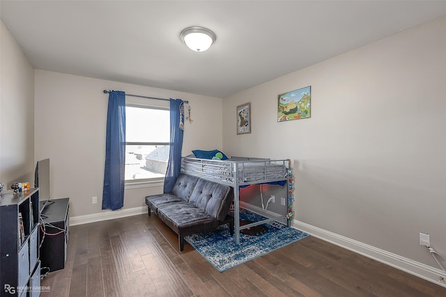 bedroom with dark wood-type flooring