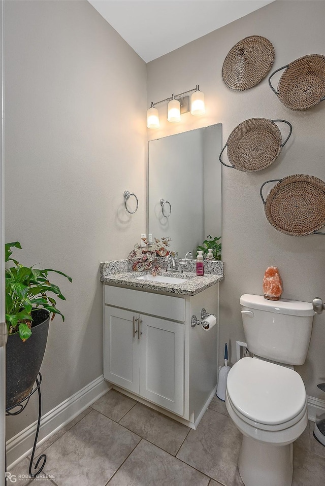 bathroom with vanity, tile patterned flooring, and toilet