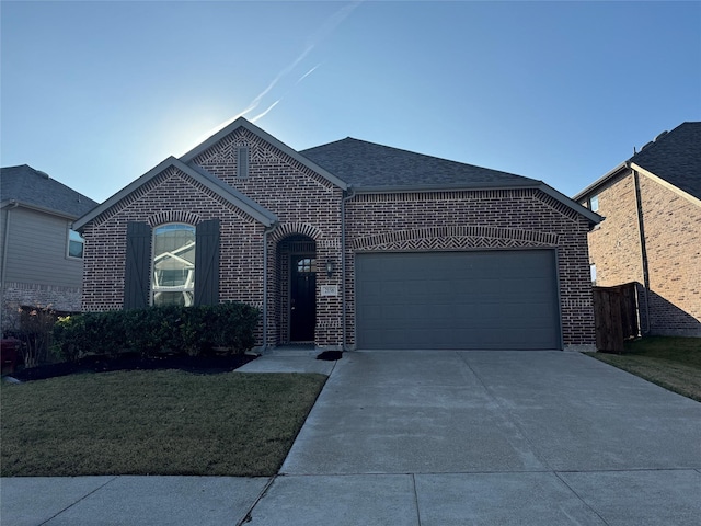 view of front of home with a garage and a front yard