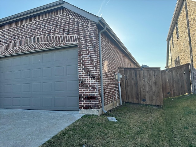 view of side of property with a yard and a garage