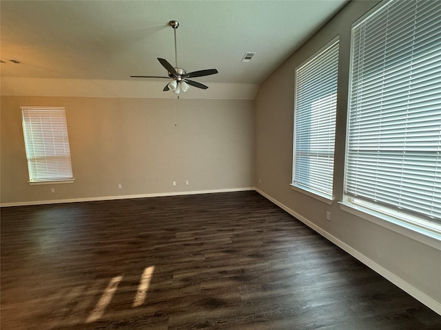 empty room with ceiling fan, dark hardwood / wood-style flooring, and lofted ceiling