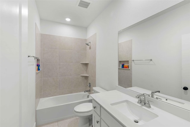 full bathroom featuring tile patterned flooring, vanity, toilet, and tiled shower / bath