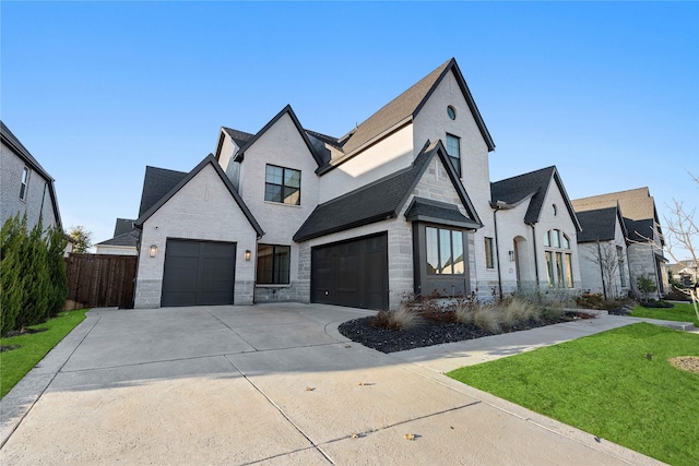 french provincial home with a garage and a front yard