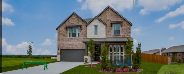 view of front of house featuring a garage and a front yard