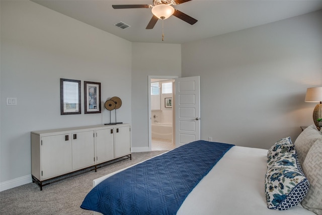 carpeted bedroom with connected bathroom and ceiling fan