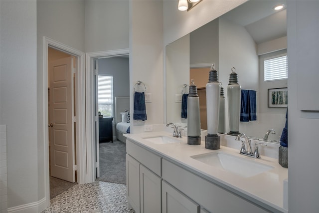 bathroom with lofted ceiling, a healthy amount of sunlight, and vanity