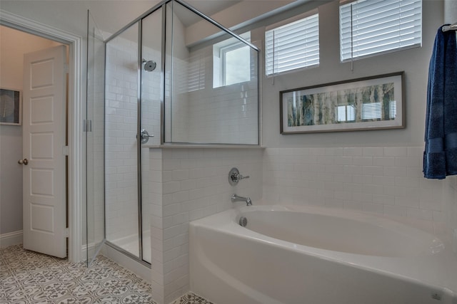 bathroom with shower with separate bathtub and tile patterned flooring