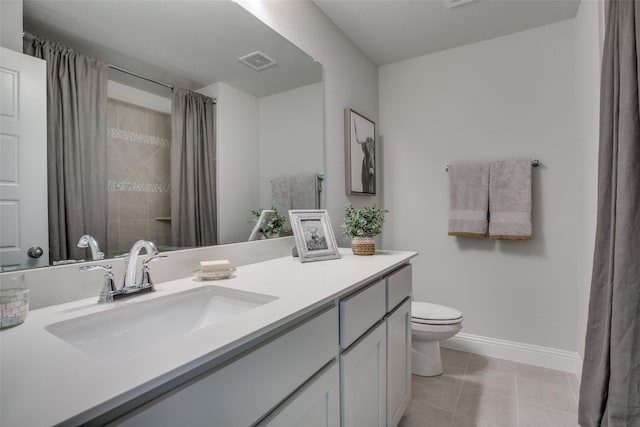 bathroom with tile patterned flooring, vanity, and toilet