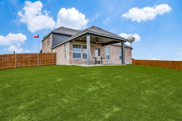 back of property featuring ceiling fan, a patio area, and a lawn