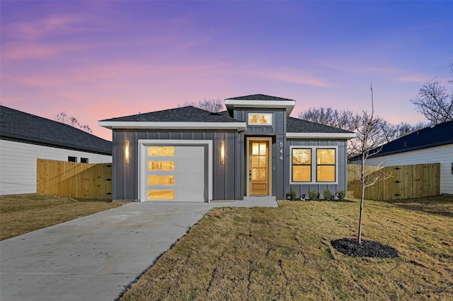 view of front facade with a garage and a yard