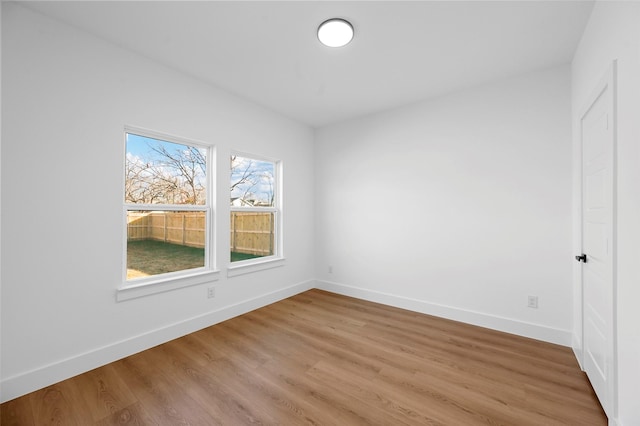 empty room with hardwood / wood-style flooring