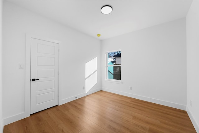 empty room with hardwood / wood-style floors