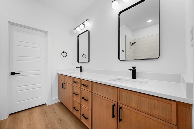 bathroom with vanity, wood-type flooring, and walk in shower