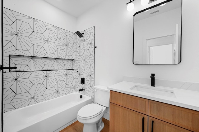 full bathroom featuring hardwood / wood-style floors, vanity, toilet, and bathing tub / shower combination