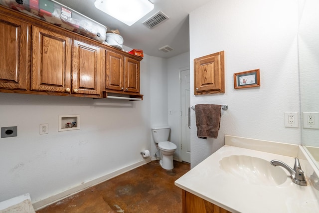 bathroom featuring vanity, concrete floors, and toilet