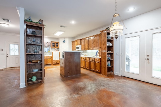 kitchen featuring a center island, pendant lighting, french doors, and an inviting chandelier