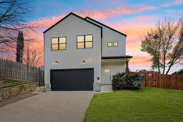 view of front facade with a garage and a lawn