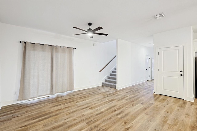 empty room with light hardwood / wood-style flooring and ceiling fan