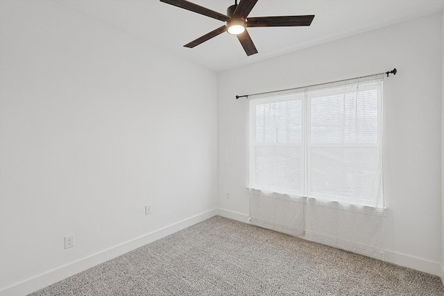 empty room with carpet, ceiling fan, and baseboards