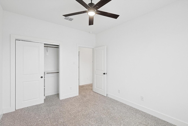 unfurnished bedroom with light carpet, a closet, and ceiling fan