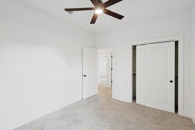 unfurnished bedroom featuring light colored carpet, a closet, and ceiling fan