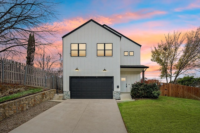 modern inspired farmhouse featuring a yard and a garage