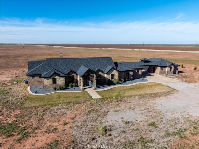 view of front of house with a rural view