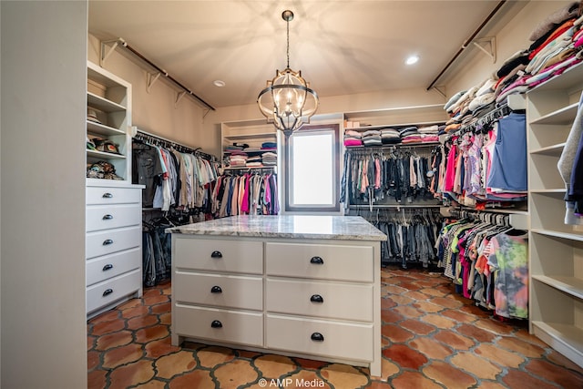 spacious closet featuring a chandelier