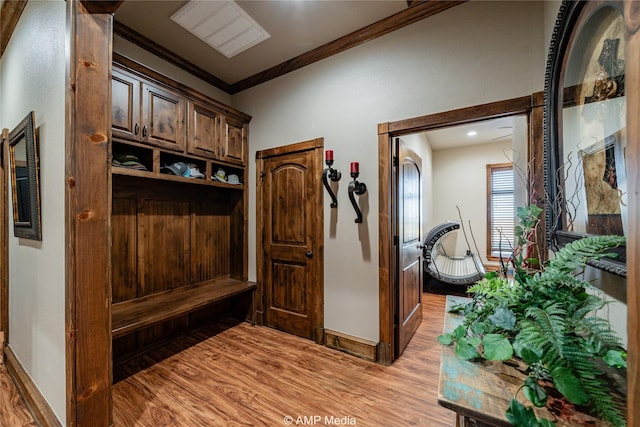 mudroom with crown molding and light hardwood / wood-style flooring