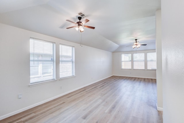 unfurnished room with ceiling fan, lofted ceiling, and light hardwood / wood-style flooring