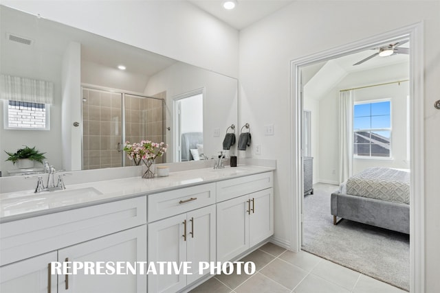 bathroom with ceiling fan, tile patterned flooring, vanity, and a shower with door