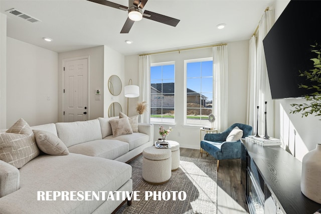 living room featuring wood-type flooring and ceiling fan