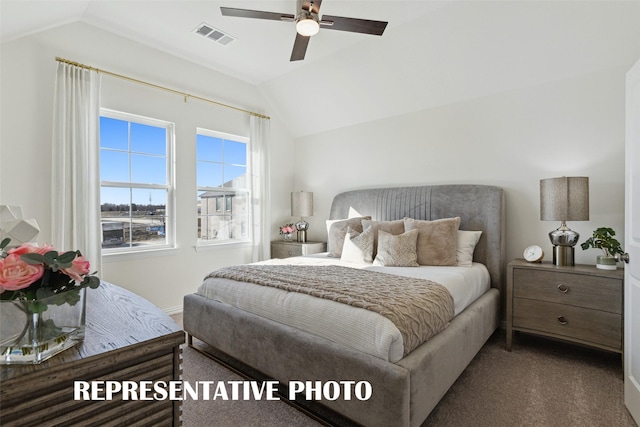 carpeted bedroom with ceiling fan and lofted ceiling