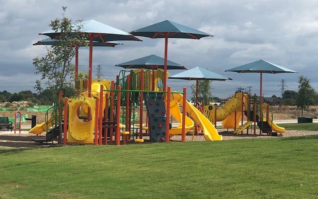 view of jungle gym with a lawn