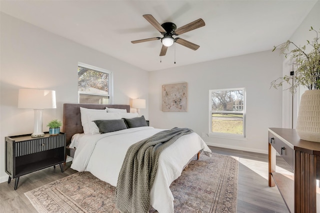 bedroom with light wood-type flooring and ceiling fan