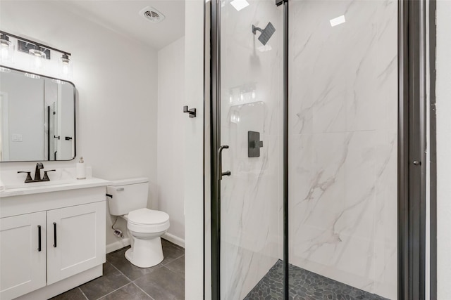 bathroom with toilet, a shower with shower door, tile patterned floors, and vanity