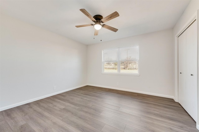 unfurnished bedroom featuring light wood-type flooring, a closet, and ceiling fan