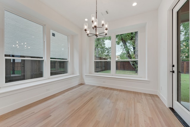 interior space with an inviting chandelier and light wood-type flooring