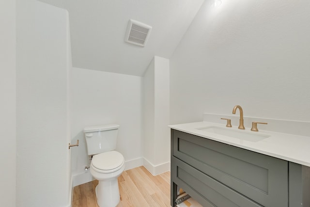 bathroom with vanity, hardwood / wood-style floors, and toilet