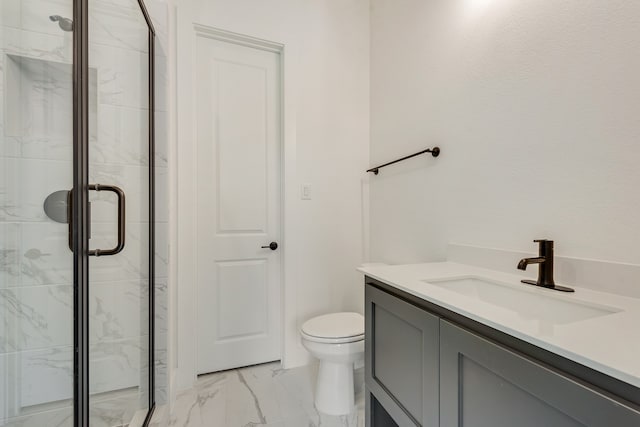 bathroom featuring vanity, toilet, and a shower with shower door