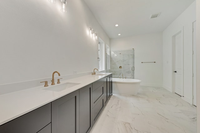 bathroom with vanity and independent shower and bath