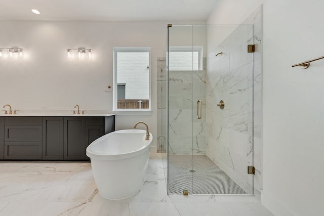 bathroom featuring vanity and independent shower and bath