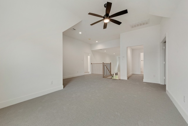 unfurnished living room with light colored carpet and ceiling fan